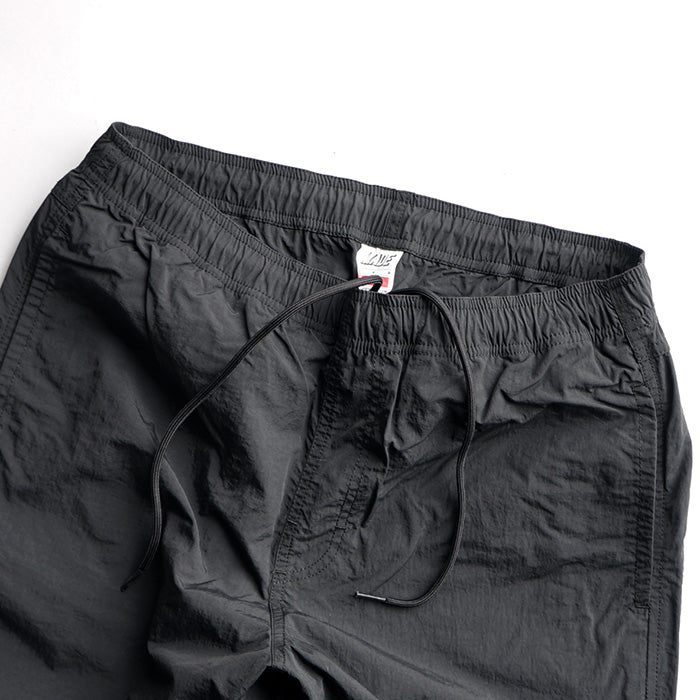 MADE WARM UP NYLON PANTS