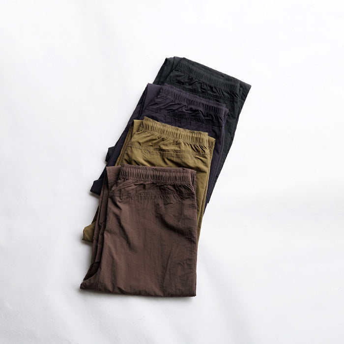 MADE WARM UP NYLON PANTS
